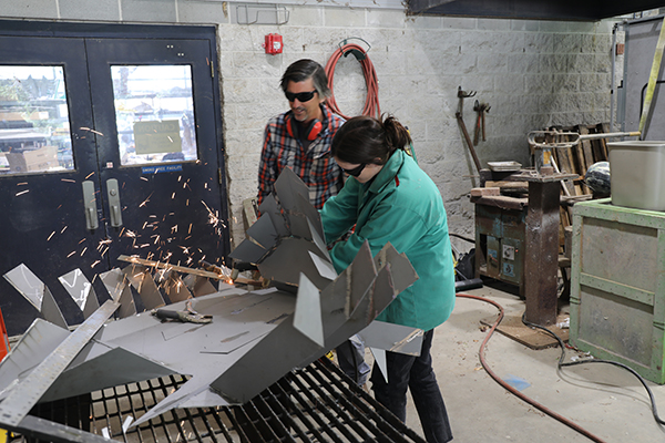 Jeff Garland and Katie Snyder work on a sculpture. 