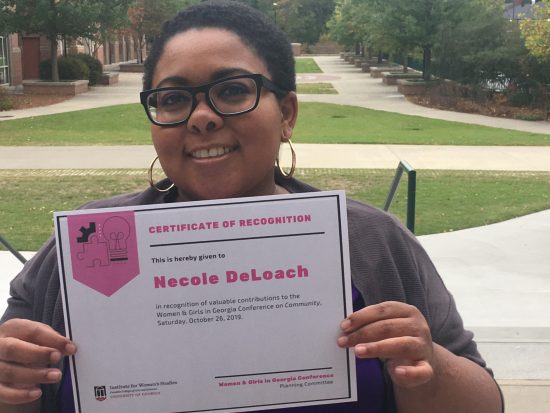 Nicole DeLoach holding a certificate of recognition from the University of Georgia for her participation in the 2019 Women and Girls in Georgia Conference