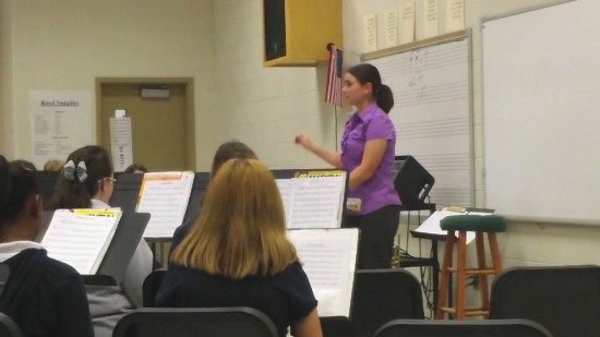Conductor instructing orchestra.