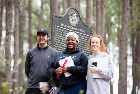 three students at historical site